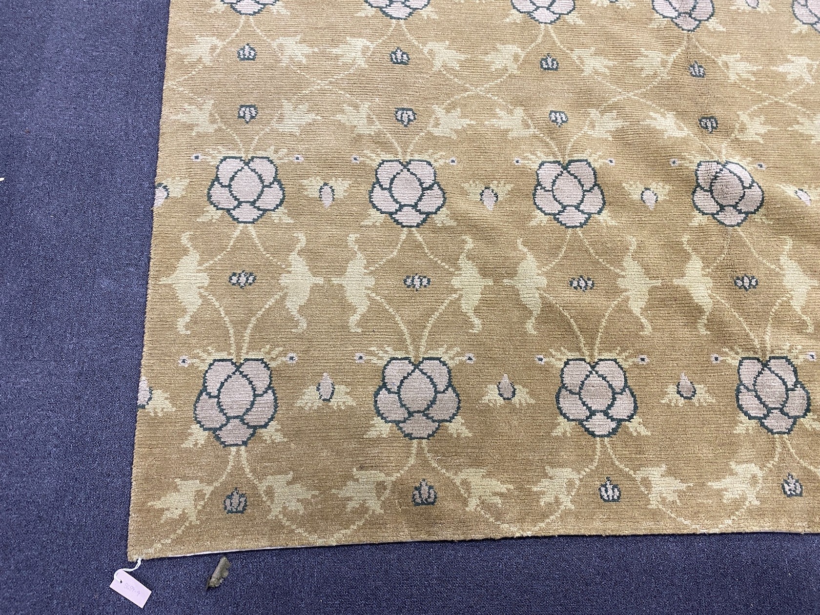 An Arts and Crafts style pale green ground carpet, 300 x 250cm